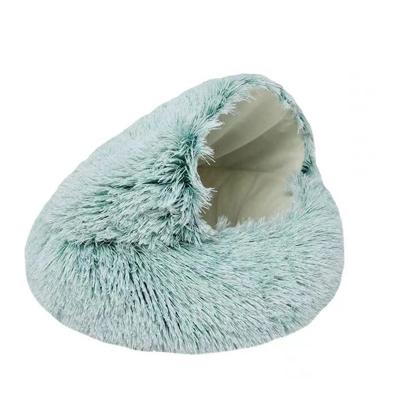 A light blue fluffy round plush pet bed with a removable cover.
