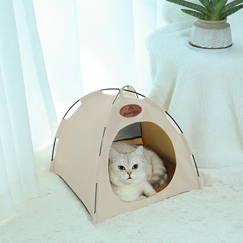 A beige foldable outdoor cat tent with an entrance for a small cat resting inside.