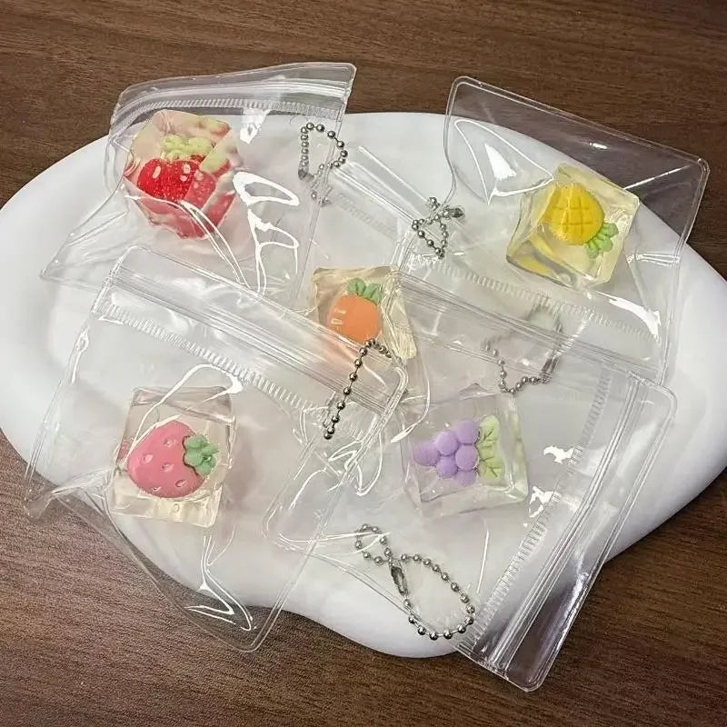 Clear plastic bags contain various squishy bread fidget toys and jewelry items on a white plate.