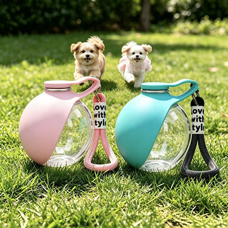 Pink and teal portable dog water bottles with silicone straps sitting on green grass near two small dogs.