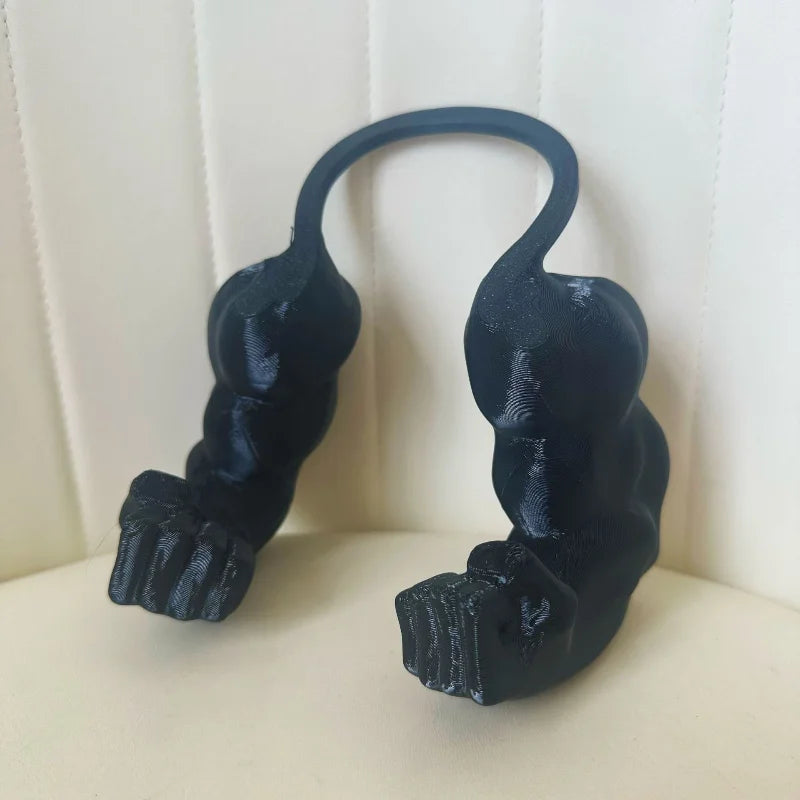 A black 3D printed accessory shaped like a cat muscle arm, displayed against a light background.