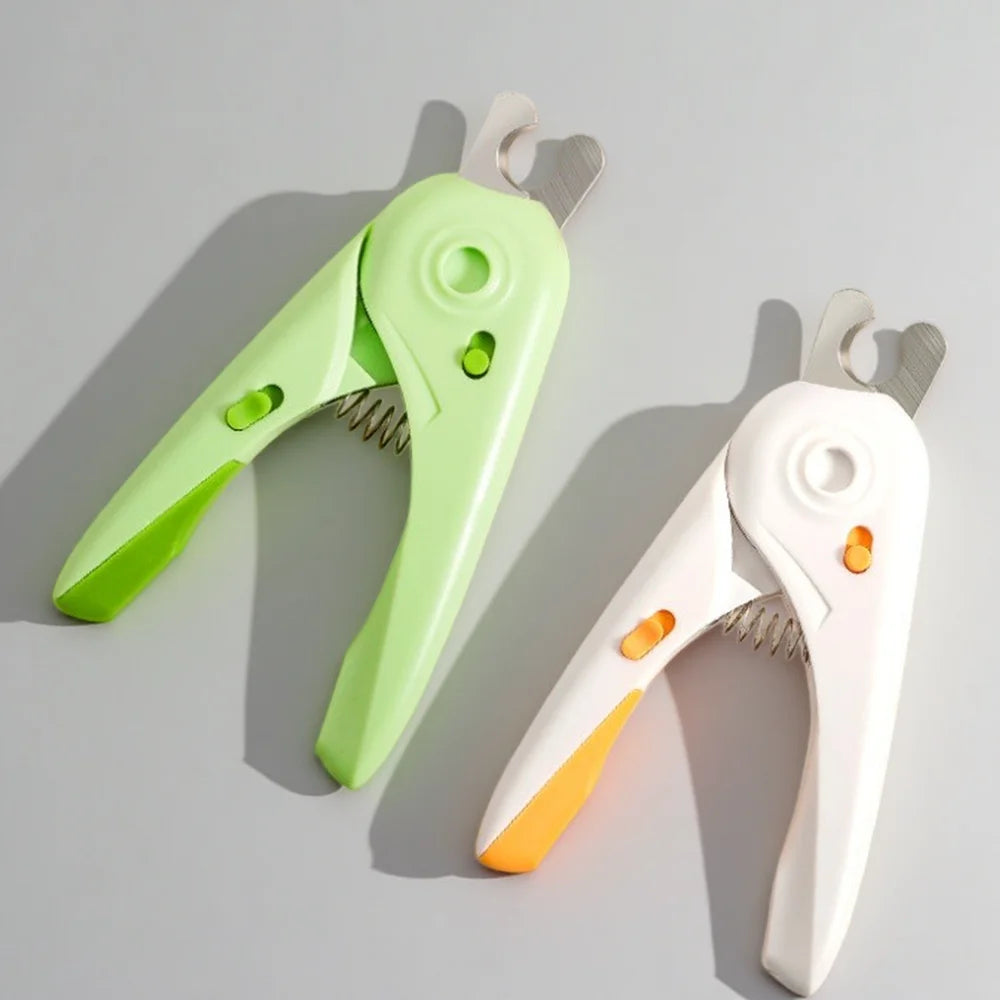 A pair of light green and white pet nail clippers for dogs and cats lying on a gray surface.