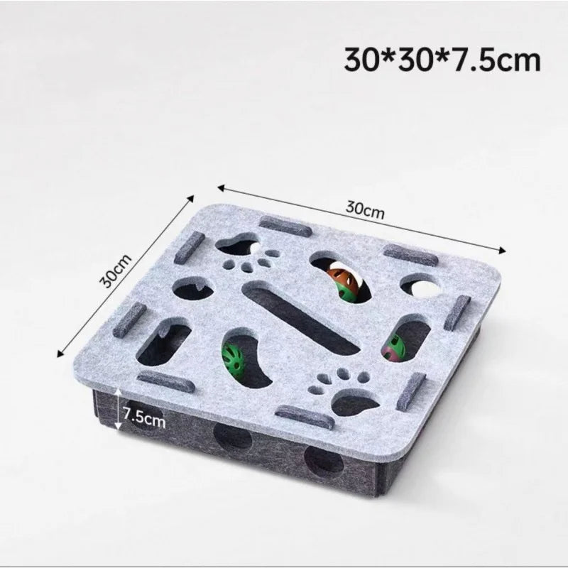A grey felt maze puzzle toy for cats with a bell ball, showing various holes and maze paths.