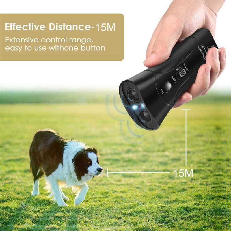 A hand holds a black ultrasonic dog deterrent device, demonstrating its 15-meter range over green grass.