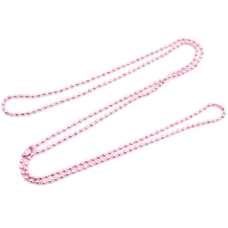 A set of gold and silver plated ball necklaces laid out on a white background.