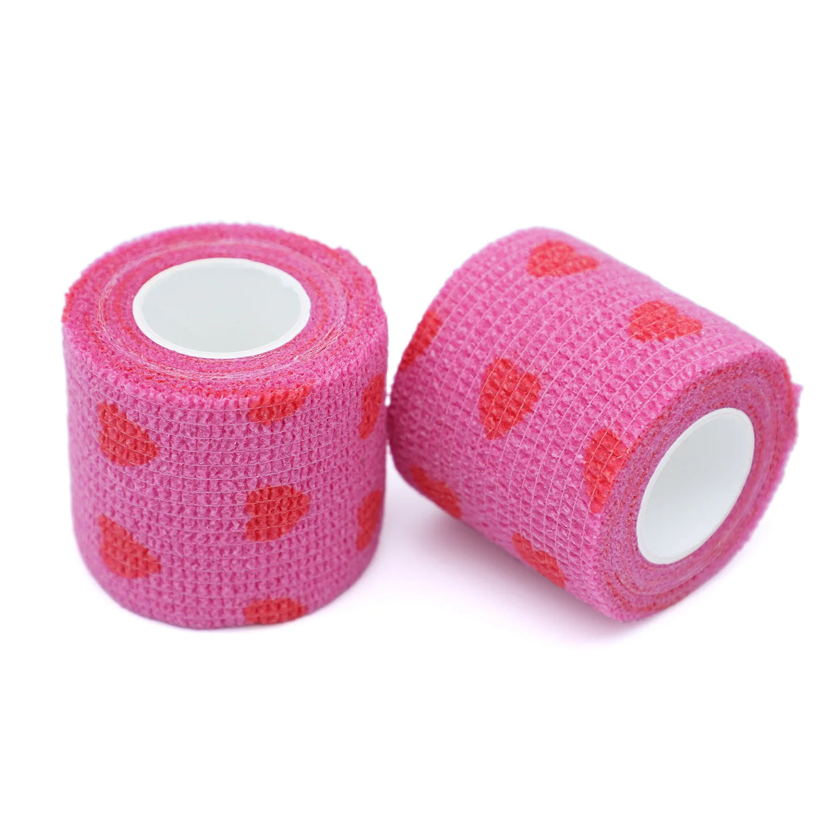 Zwei Rollen rosa selbstklebende Tätowier-Griffbinden mit kleinen roten Herzen