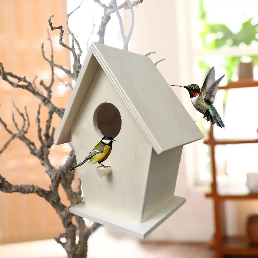 A white wooden wall-mounted bird house with a small bird perched on its entrance.