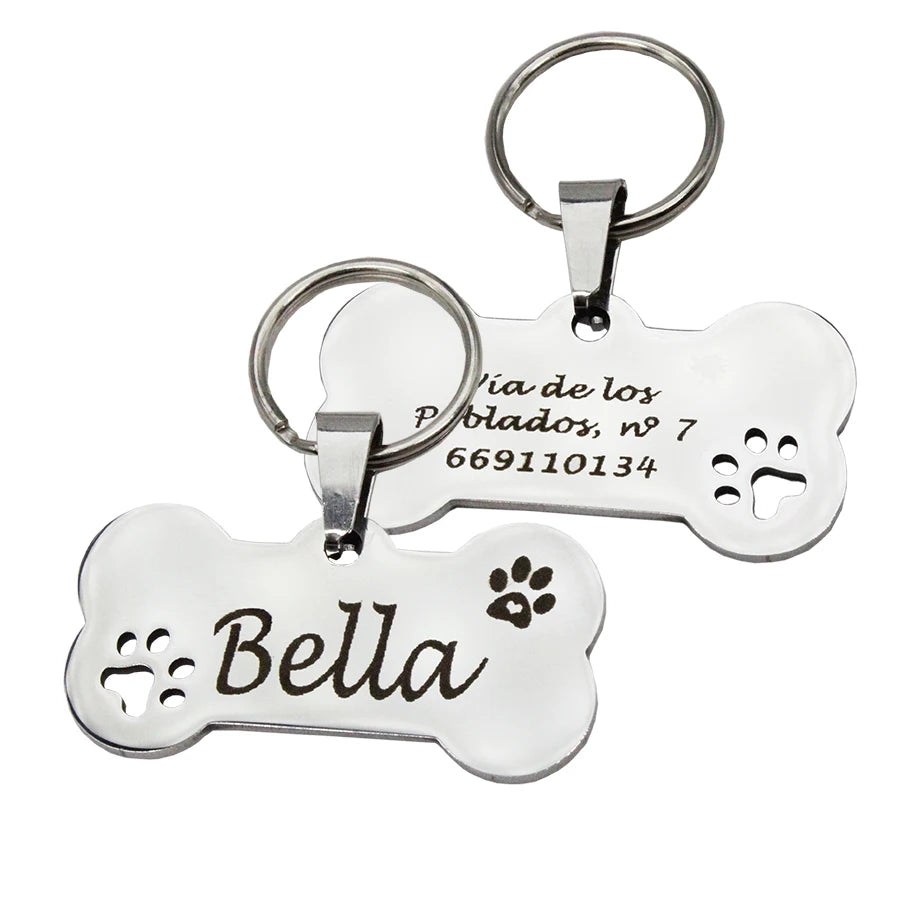 Silver stainless steel pet ID tag with a paw print design and the name Bella engraved on it