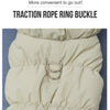 Close-up of a beige quilted dog jacket showing a brass traction rope ring buckle closure.