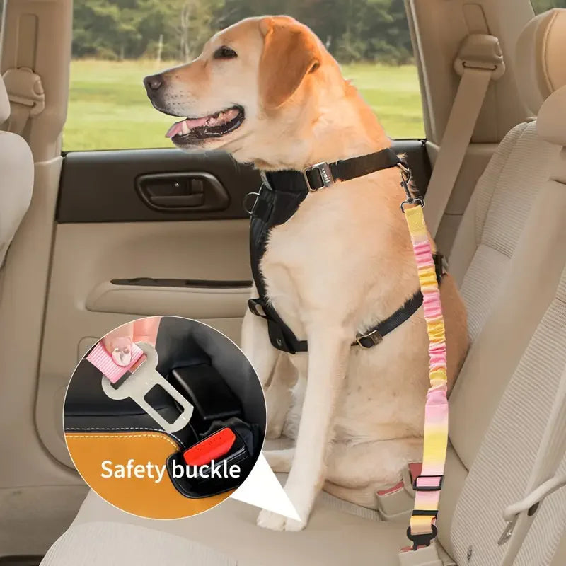 A golden retriever wearing an adjustable traction rope safety harness sitting in a car seat.