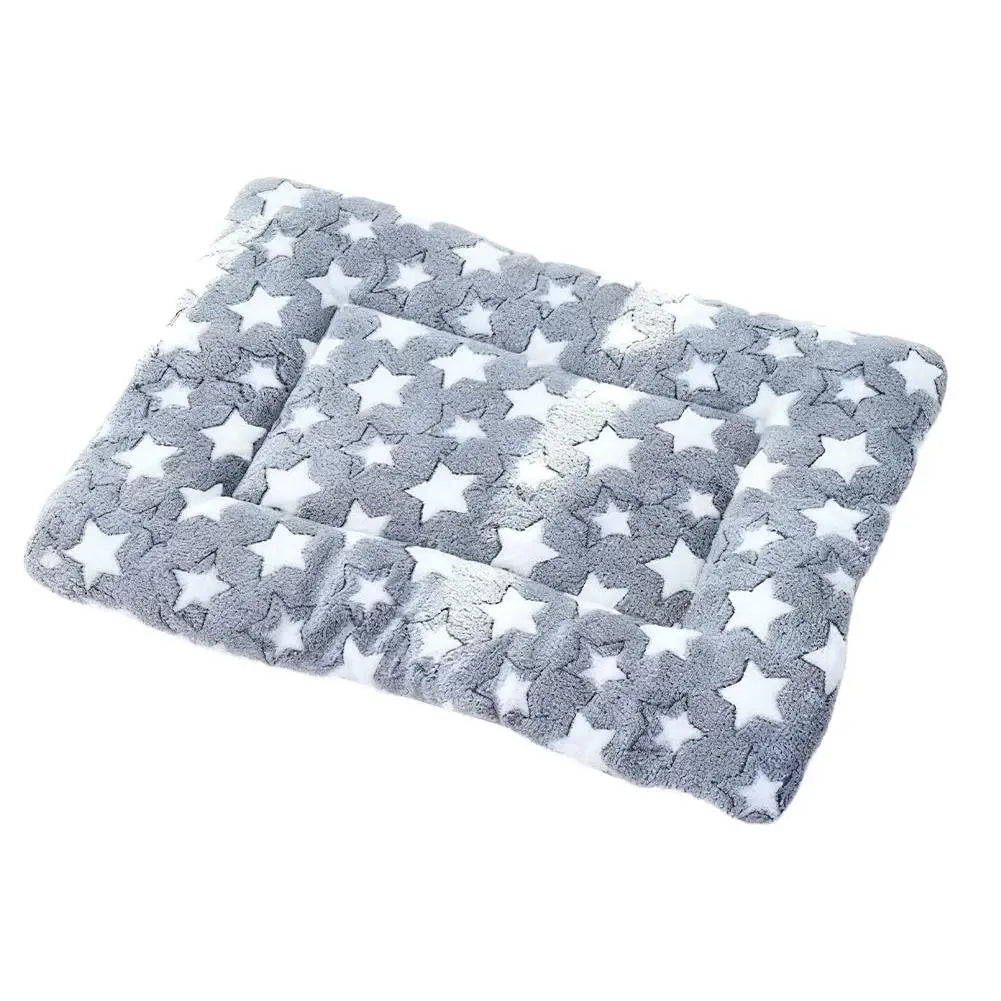 A gray and white plush double-sided pet blanket or mat with a star pattern.