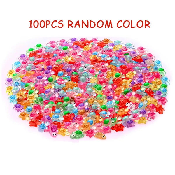 100 pieces of random color glow-in-the-dark resin turtle figurines scattered on a white background