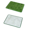 A rectangular mat of green artificial dog grass used for potty training.