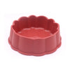A pink non-slip pet feeding bowl for food and water with a fluted rim.