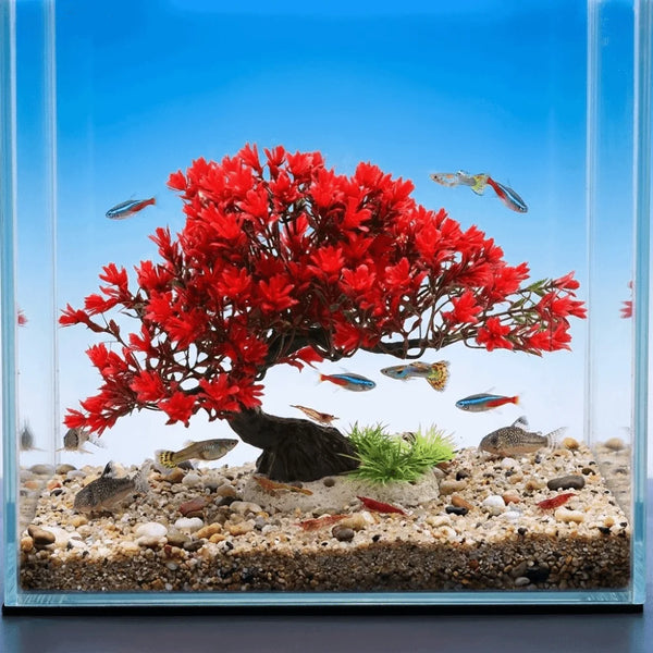 Lifelike artificial aquarium plant shaped like a red pine tree with fish swimming in clear water.