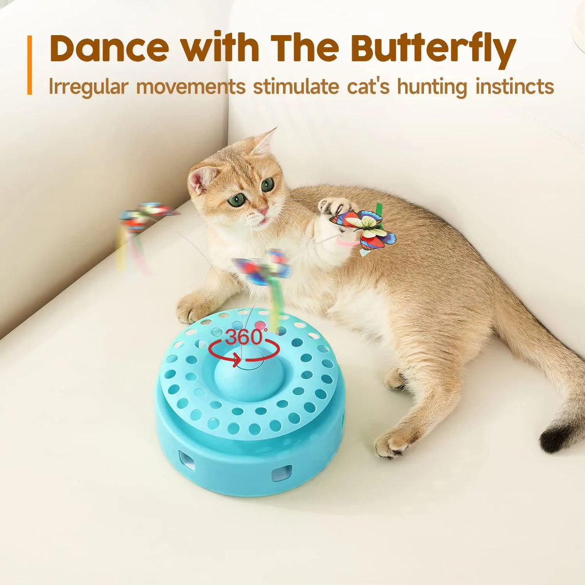 A tabby cat interacts with a blue spinning toy featuring fluttering butterfly and feather elements.