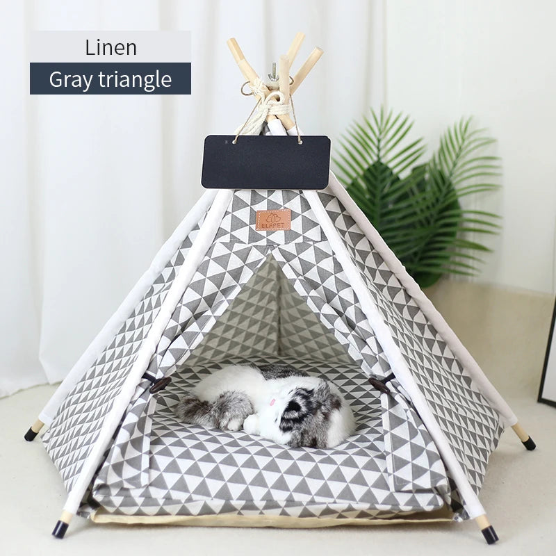 Tente triangle en lin gris avec coussin et tableau noir, montrant un animal de compagnie qui dort à l'intérieur.