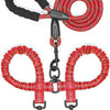A red and black double dog leash with a shock absorbing bungee and metal clips.