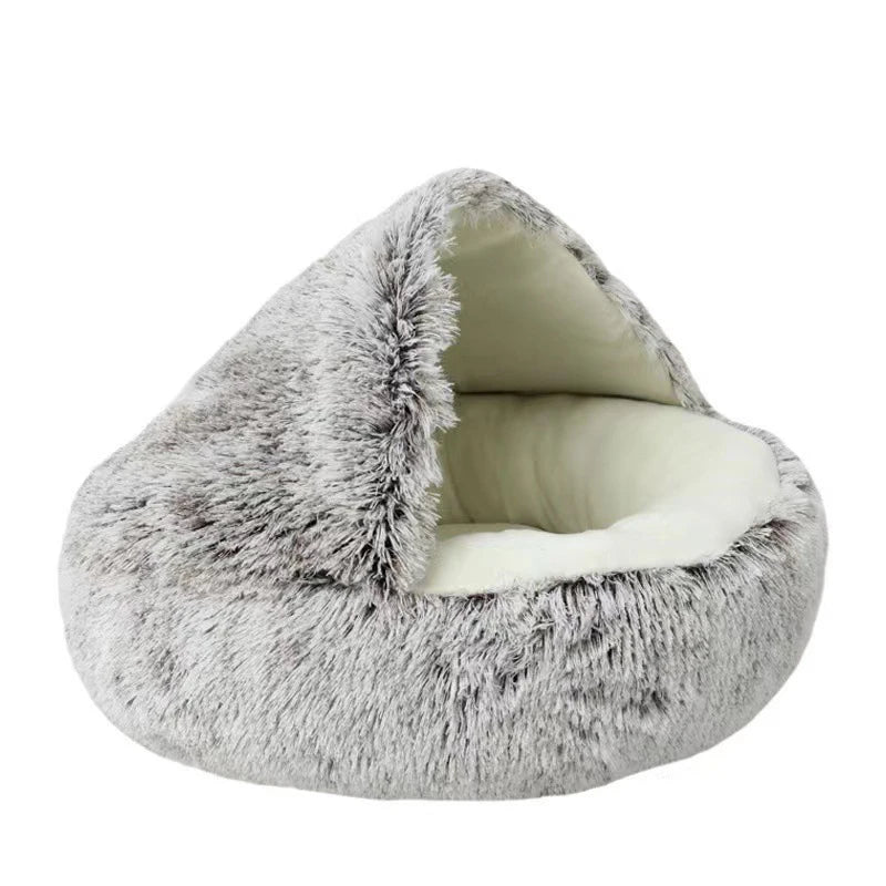 A round, gray faux fur pet bed with a removable white cover.