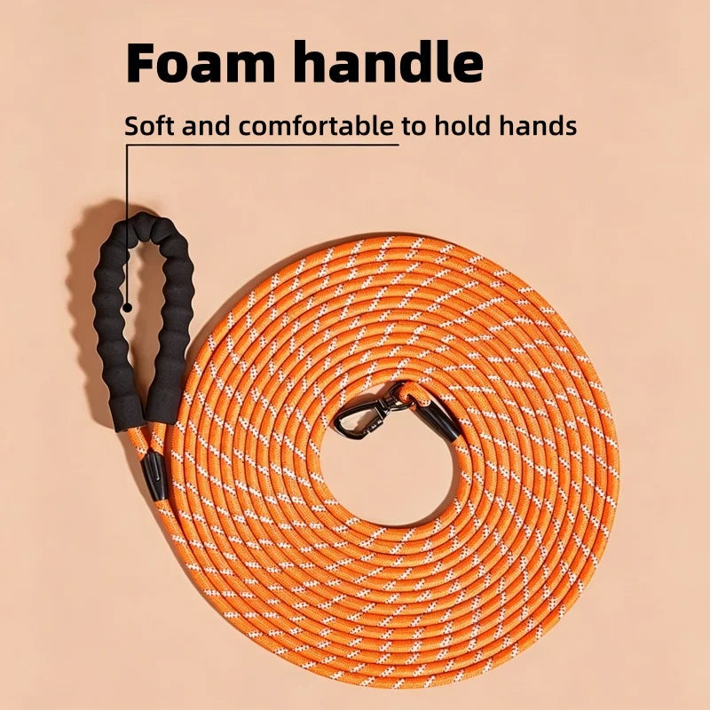 Orange reflective nylon dog leash with a foam handle coiled on a light background.