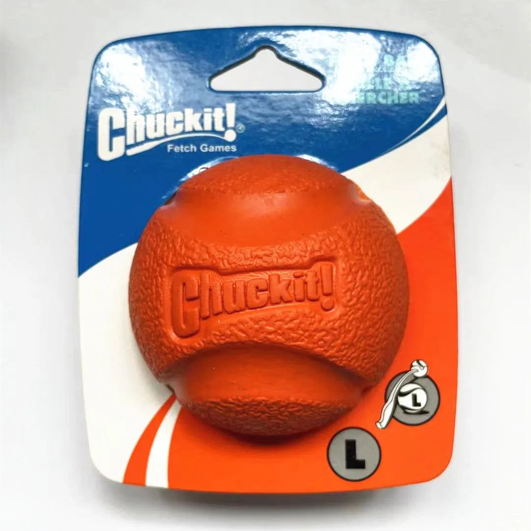 An orange Chuckit fetch ball is shown in a clear plastic package.