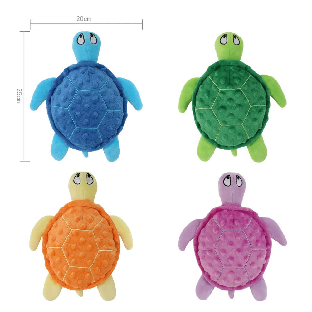 Four plush toy turtles in blue, green, orange, and purple colors