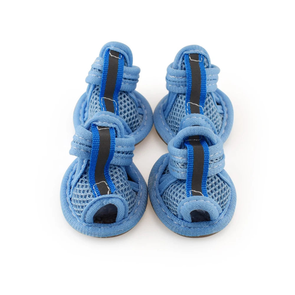 A pair of blue breathable summer dog shoes with mesh and blue laces
