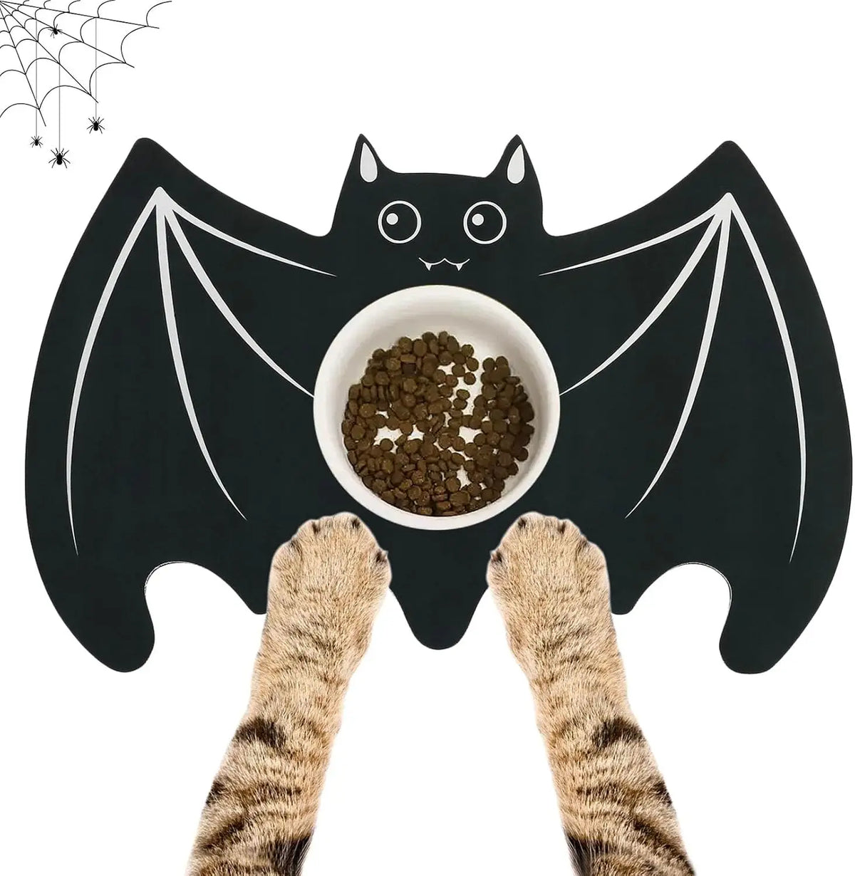 A black bat-shaped Halloween pet feeding mat with a spider web design and a bowl of pet food.
