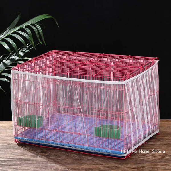 A clear mesh bird cage cover with a red frame and blue base resting on a wooden surface.