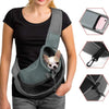 A woman wearing a black shirt is holding a gray mesh pet sling carrier for small dogs and cats.