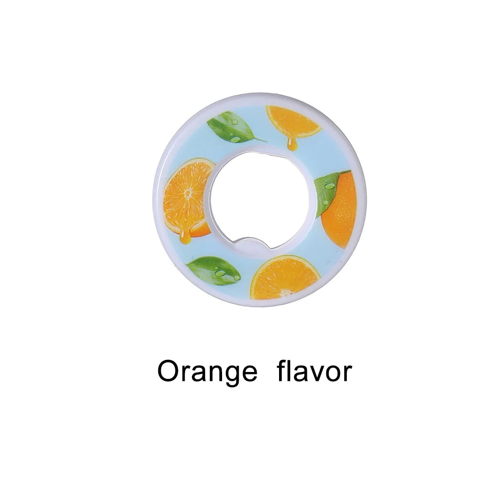 A circular flavor pod for water bottles featuring slices of orange and green leaves, indicating an orange flavor.