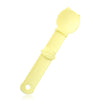 A yellow squeeze spoon feeder for liquid cat treats.