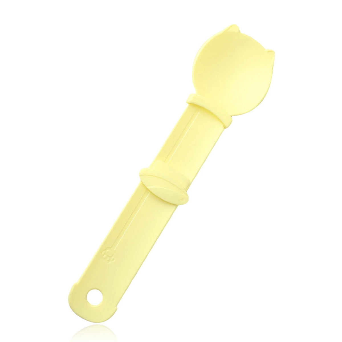 A yellow squeeze spoon feeder for liquid cat treats.