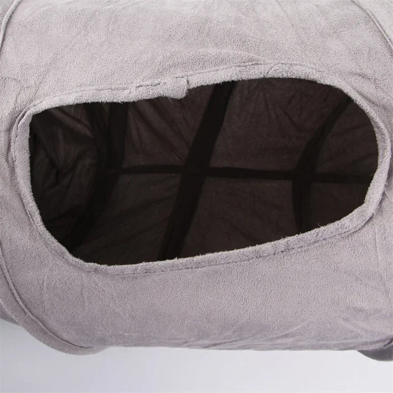 A light gray foldable S-shape cat tunnel with a suede finish, showing the interior opening.