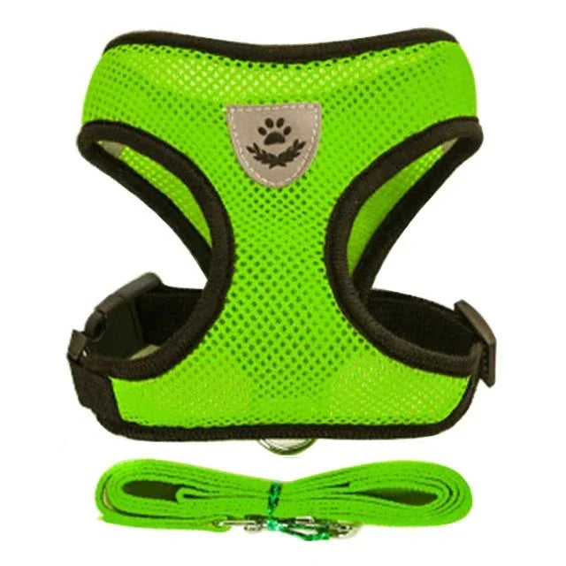 A bright lime green mesh pet harness vest with black trim and reflective trim lying on a white background.