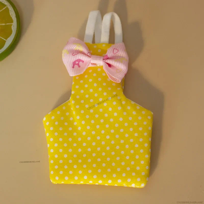 Yellow parrot flight suit with a pink bow tie and white polka dots
