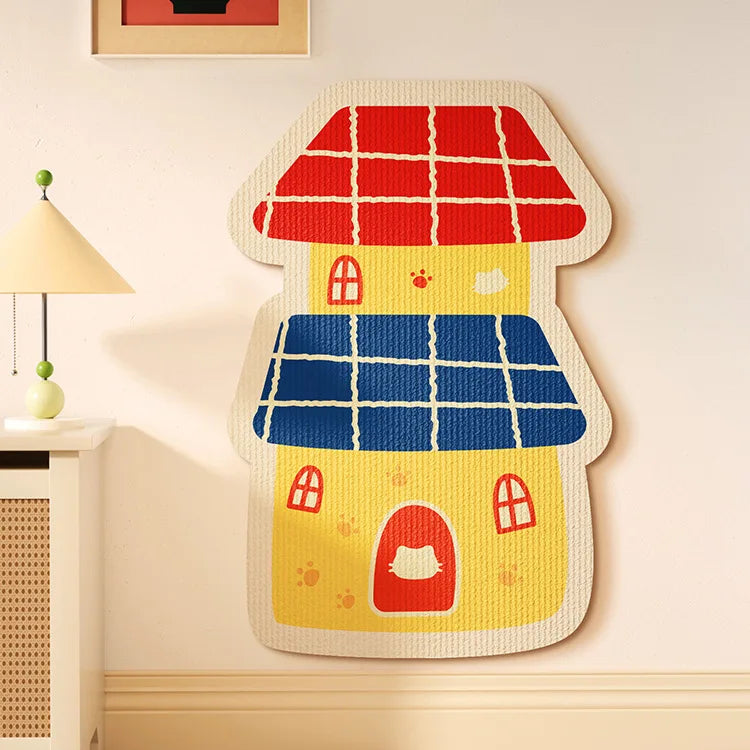 A felt cat scratch board shaped like a house with red roof and blue siding mounted on a wall.