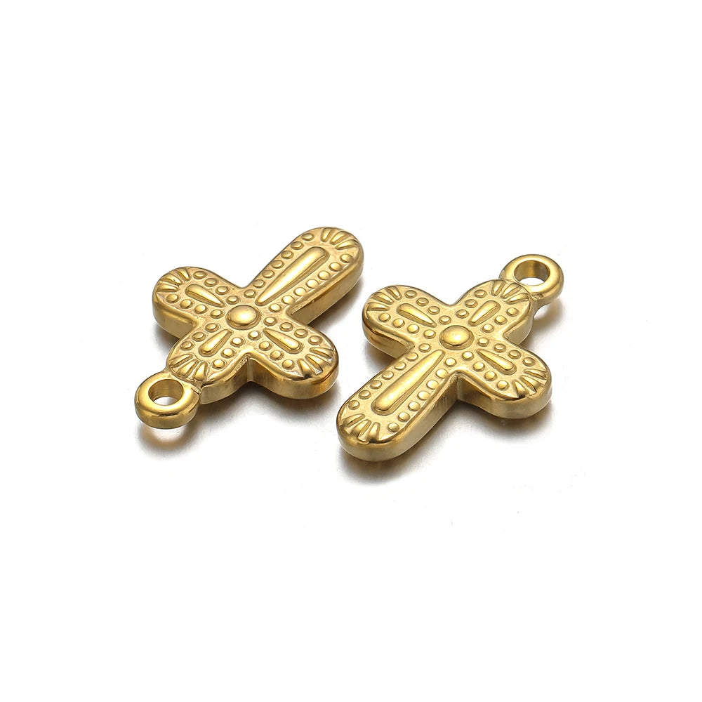 A pair of vintage gold-toned cross charms used for DIY jewelry making.