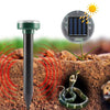 A solar ultrasonic pest repeller device is shown next to a green snake in soil.