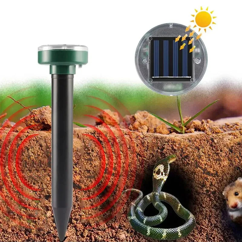 A solar ultrasonic pest repeller device is shown next to a green snake in soil.