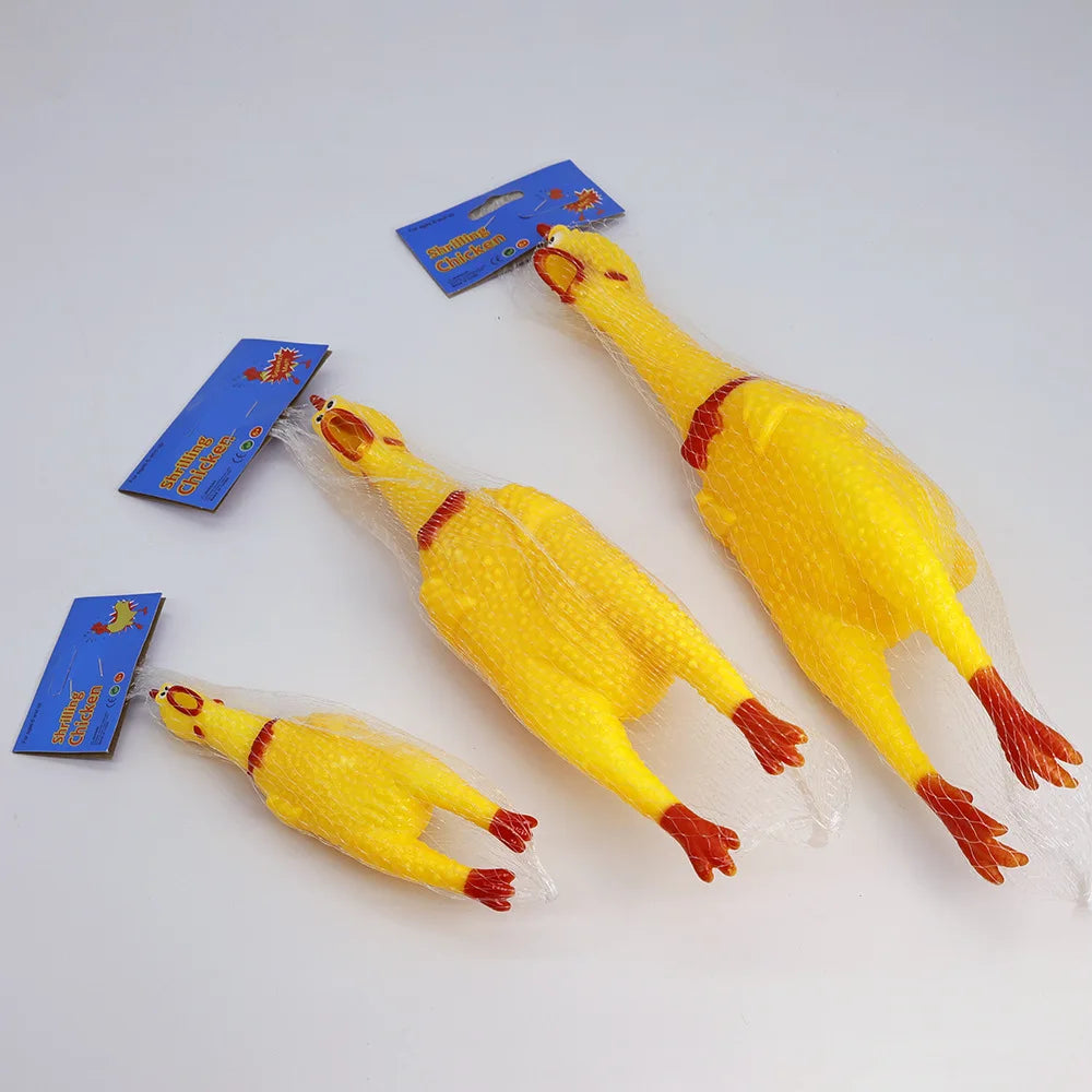 Gelbes quipefähiges Gummihühner-Hundspielzeug mit Verpackung