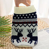 A knitted pet sweater for dogs and cats featuring a festive pattern in white, navy blue, and red.