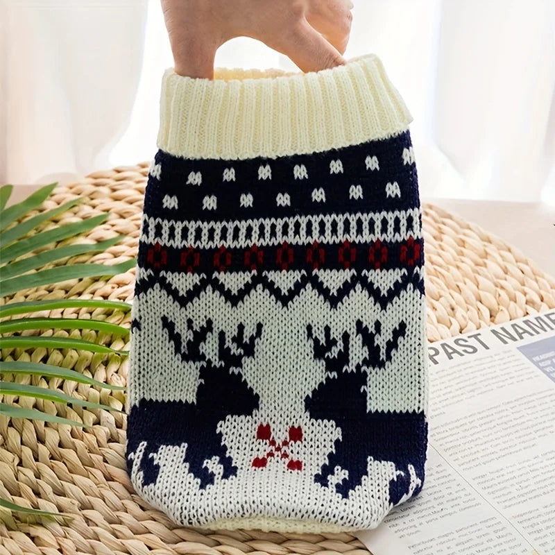 A knitted pet sweater for dogs and cats featuring a festive pattern in white, navy blue, and red.