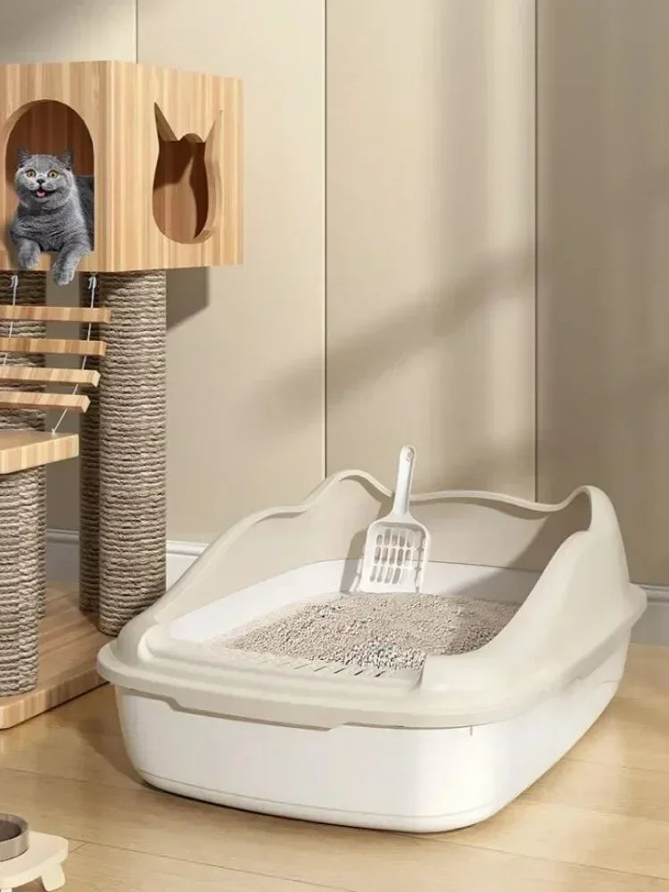 A white high-sided cat litter box with a built-in scoop is shown on a wooden floor.