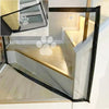 A portable folding pet safety gate with a black frame and breathable mesh, shown in an angled view.