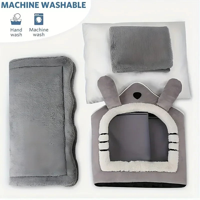 A gray foldable pet house with a removable, washable cover shown next to hand and machine wash icons.