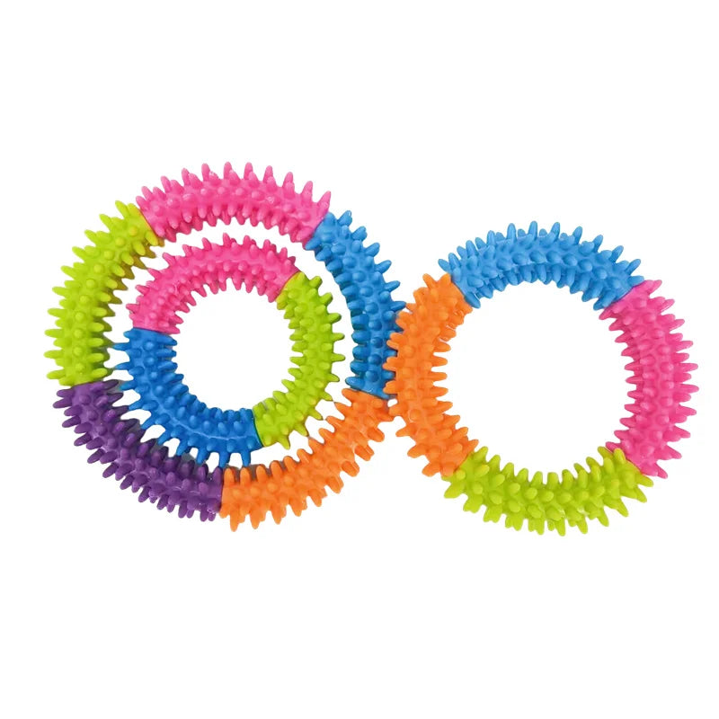 A set of colorful spiky ring dog chew toys for teeth cleaning and fetch play
