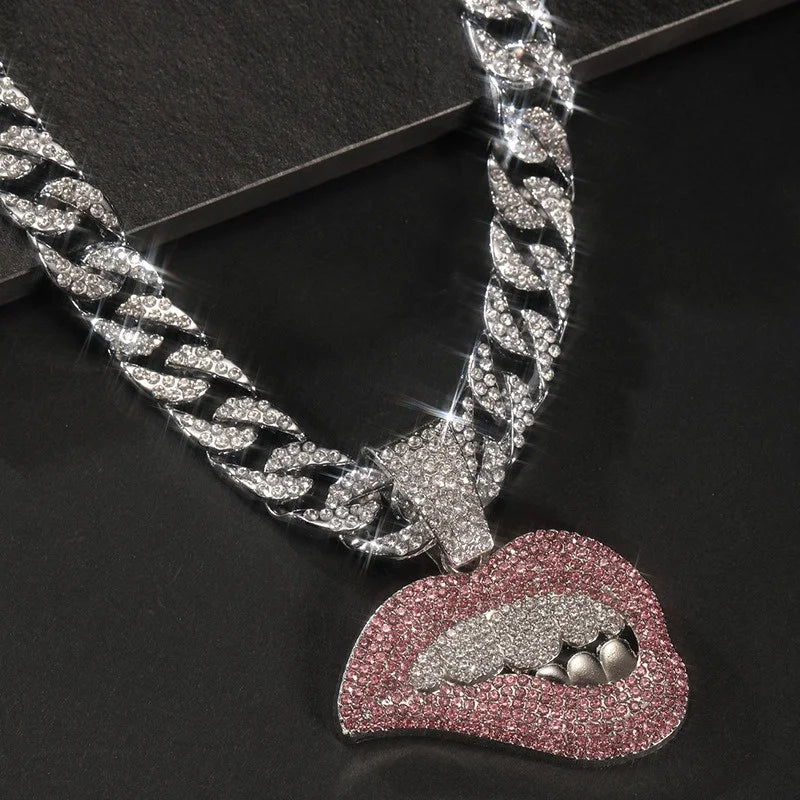 Silver iced out letter and animal pendant on a Cuban link chain necklace