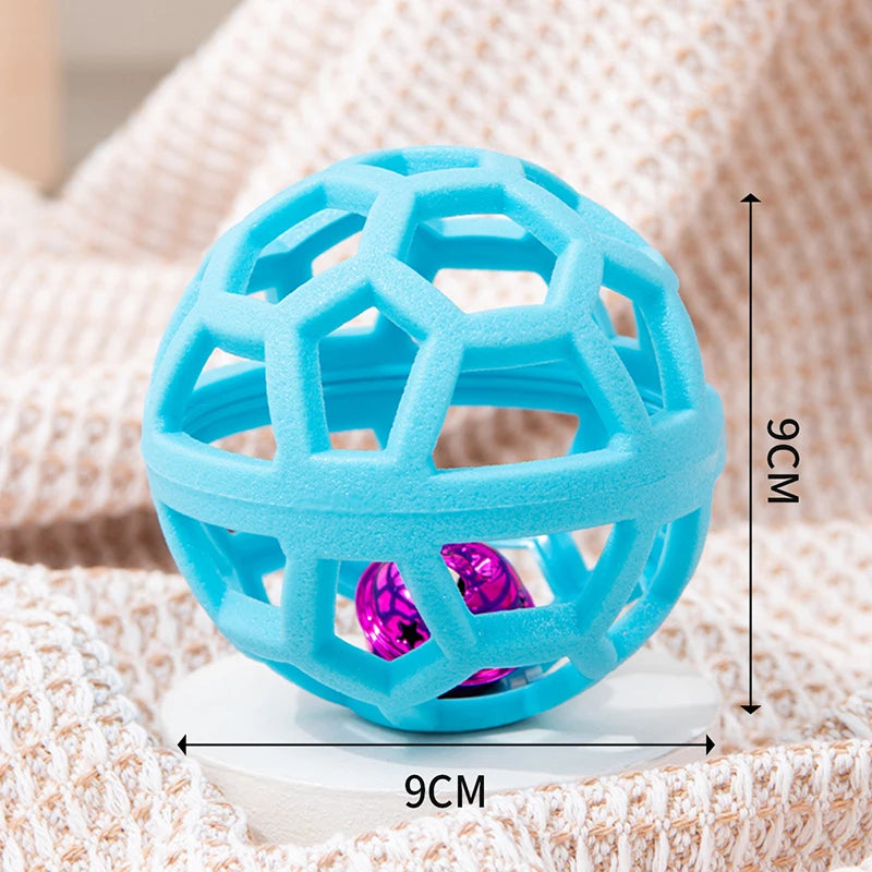 A bright blue natural rubber dog chew ball with a bell is shown resting on a white surface.