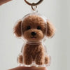 Un porte-clés en silicone transparent avec une petite figurine de chien brun et duvete.